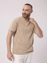 Remera color beige con efecto nevado, de corte recto y manga corta.