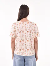 Remera de manga corta con estampado abstracto en tonos beige, negro y blanco.