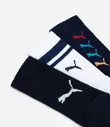 Kit de tres pares de medias deportivas Puma de caña larga. Un par color beige con dos rayas marrones horizontales en la parte superior y logo marrón en el tobillo. Un par color crema liso con logo blanco en el tobillo. Un par color marrón con una raya blanca horizontal en la parte superior y logo blanco en el tobillo.