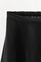 Shorts negro de viscosa con cintura elástica y puntilla en el ruedo.