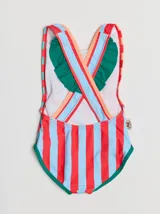 Malla enteriza de lycra con rayas verticales rojas y celestes en el frente, laterales con rayas horizontales naranjas y turquesas, terminaciones con ribete verde y espalda blanca.