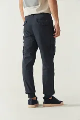 Pantalón cargo color marrón claro, con corte regular, puños elásticos y bolsillos laterales con solapa.