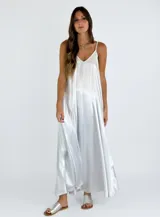 Vestido largo plateado de breteles finos y corte suelto.