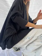 Remera blanca de corte amplio y mangas largas.