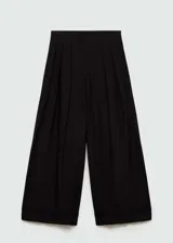 Pantalón negro de corte ancho con tablas, tejido fluido y largo hasta el tobillo.