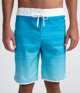 Bermuda de baño tipo boardshort con estampado degradado en tonos celeste y azul, cintura fija con lazo de ajuste y barra redondeada.