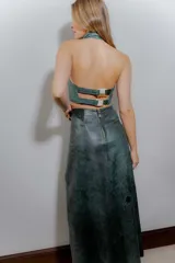 Falda midi de cuero ovino color verde azulado con efecto desgastado. Presenta tajo lateral con cordones cruzados.