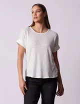 Remera color durazno con textura y espalda con aplique de botones.