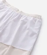 Conjunto de pijama para hombre, color blanco hueso, compuesto por una camisa de manga corta con cuello solapa y cierre frontal de botones, y un short con cintura elástica y lazo.