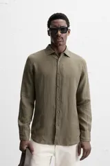 Camisa celeste de lino, de corte recto, manga larga y cuello clásico.