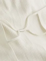 Top blanco de Calvin Klein con cuello halter y espalda descubierta.
