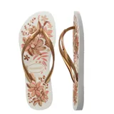 Sandalias Havaianas Slim Organic, con base blanca estampada con flores en tonos marrones y tiras doradas.
