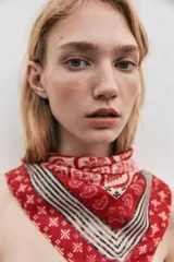 Pañuelo cuadrado de satén color rojo con estampado de cachemir y borde con diseño geométrico.