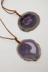 Collar con dije de ágata azul y blanca, con cordón de cuero marrón ajustable.