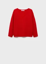 Sweater de punto color blanco con escote en V y corte holgado.