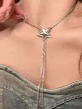 Collar plateado con dije en forma de estrella y cadena doble colgante.