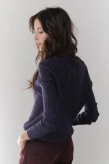 Sweater de punto marrón con escote en V y mangas largas.