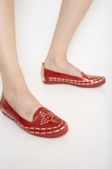 Ballerinas color verde oliva con calados geométricos y fondo dorado.