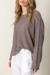 Sweater de lurex color lila, de manga larga y corte holgado.