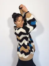 Sweater tejido a mano con lana merino, multicolor con patrón de zigzag en blanco, negro, rojo y beige.