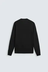 Jersey color topo de corte amplio, tejido en hilatura con mezcla de viscosa. Tiene cuello redondo, manga larga y terminaciones en rib.
