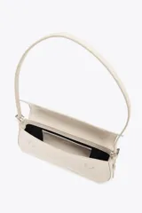 Bolso de hombro color crema con efecto acharolado, solapa con cierre magnético y asa ajustable.