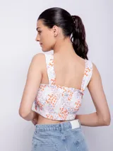 Top sin mangas de corte ajustado, con estampado geométrico en verde.