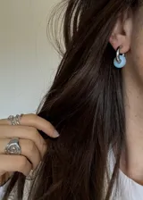 Aros de acero con acabado PVD de titanio, con dije desmontable de piedra luna.