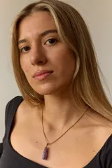 Collar dorado con cadena fina y dije colgante en forma de lágrima de piedra natural azul con vetas blancas.