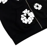 Campera con capucha y cierre frontal, color negro con estampado de coronas de algodón blancas.