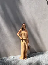 Chaleco marrón de crepé con escote en V y cierre frontal con botones.