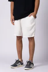 Bermudas de lino color blanco, de corte recto y largo a la rodilla. Cuenta con bolsillos laterales y cintura elástica con cordón ajustable.