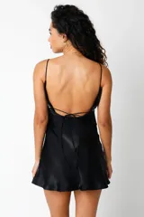 Minivestido negro de satén con breteles finos y escote recto. Presenta una banda horizontal de strass debajo del busto.
