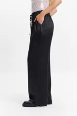 Pantalón jogger plateado de corte wide leg y cintura elastizada con lazo ajustable.