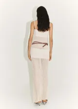 Vestido largo de punto color crema, con tirantes finos, escote cuadrado, diseño calado y cinturón marrón con tachas.