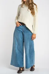 Sweater color beige de tejido texturado, con cuello redondo y mangas largas.