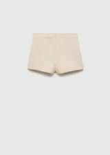 Short de vestir color beige, con bolsillos laterales y cierre invisible en la parte trasera.