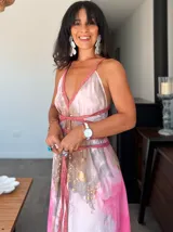 Vestido largo de tela fluida, color verde esmeralda con estampado abstracto en tonos turquesa y detalles dorados. Diseño asimétrico con un solo tirante tejido en el hombro.