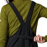 Pantalón tipo jardinero negro de softshell con tirantes ajustables, cierre frontal con cremallera, bolsillos laterales con cremallera y bolsillo en el pecho.