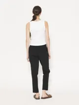 Pantalón babucha negro confeccionado en tejido 4way de alta elasticidad, con cintura elastizada y detalle metálico JCH en el frente.