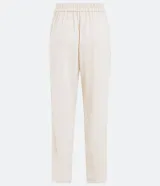 Pantalón fluido color crema, confeccionado en viscolino, con cintura elástica y lazo ajustable.