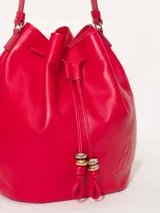Cartera tipo bucket color rojo, de cuero, con cierre de cordón ajustable y correa larga para colgar del hombro.