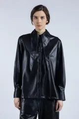 Camisa negra de cuero sintético con cuello clásico con solapas y cierre frontal con botones.