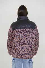 Campera puffer con estampado animal print color marrón y negro, cuello alto y cierre frontal con cremallera.