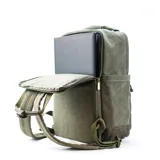Mochila marrón de tela canvas con compartimento para notebook y accesorios de mate.