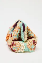 Bolso de mano tipo sobre con cuerpo cubierto de cuentas y abalorios en tonos celeste, beige, naranja y marrón. Tiene asa de cadena extraíble, bolsillo interior con cremallera y cierre con clip imantado y lazo.