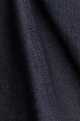 Pollera tobillera de denim de algodón rígido, color azul oscuro, con corte acampanado y cintura clásica con cierre oculto lateral.