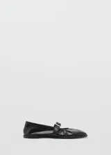 Zapato tipo bailarina color dorado, con punta redonda y tira sobre el empeine con hebilla metálica.