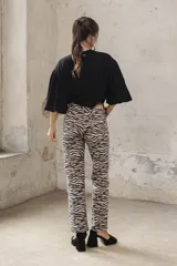 Pantalón de jean corte oxford con estampado de cebra en tonos beige y negro.