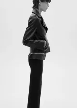 Chaqueta biker negra de cuero sintético con cuello con solapa, cierre frontal asimétrico con cremallera y bolsillos laterales con cremallera.